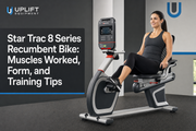 User demonstrating proper form on a Star Trac 8 Series Recumbent Bike in a commercial gym