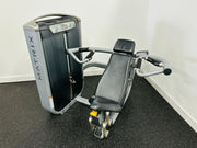 Matrix G7 Commercial Shoulder Press Machine with black and gray padding, angled handles, and a weight stack, positioned on a white and gray carpeted area.