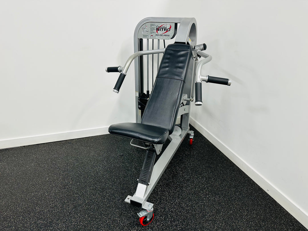 Nautilus Nitro Incline Press Machine on a black floor with white walls